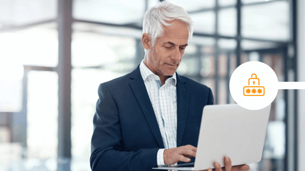 CEO looking at laptop to send secure communications
