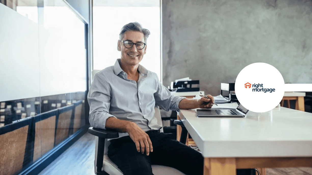 CEO smiling in office with his laptop