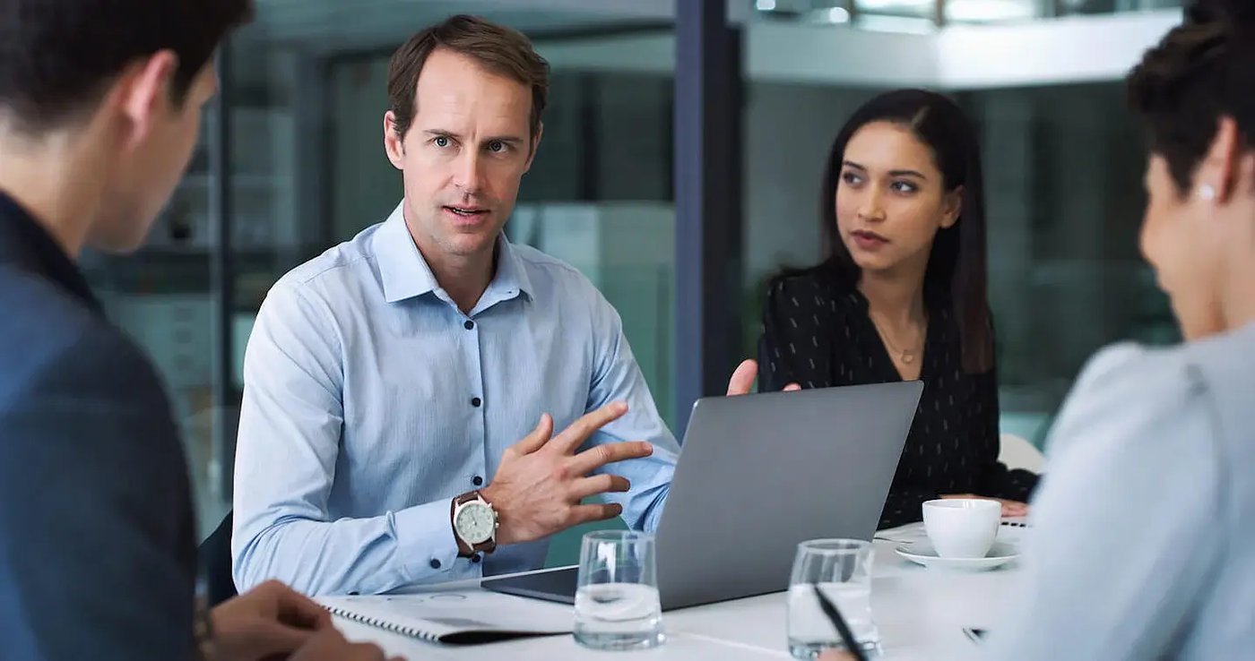 IFA explaining how email encryption works to colleagues in board room