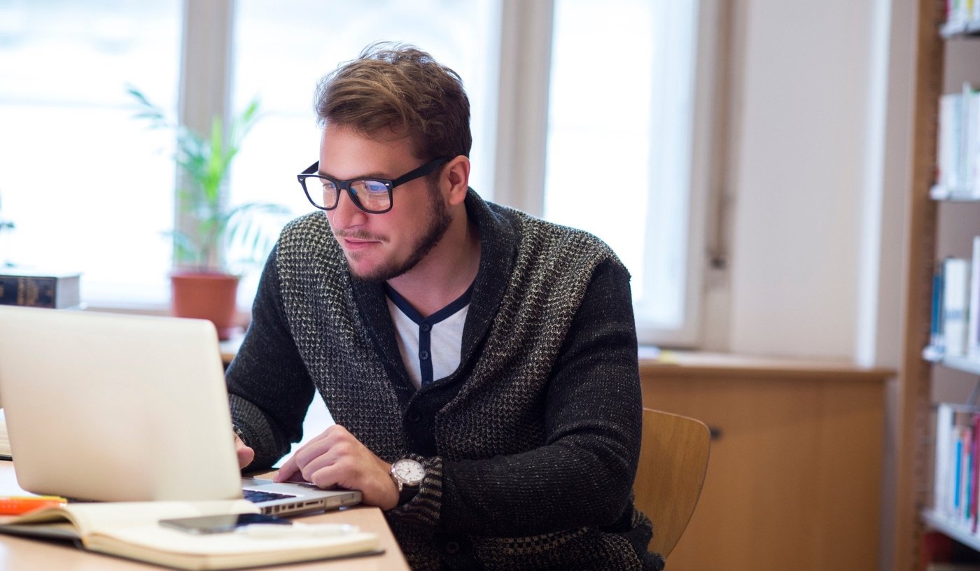 Man sitting with laptop writing secure email