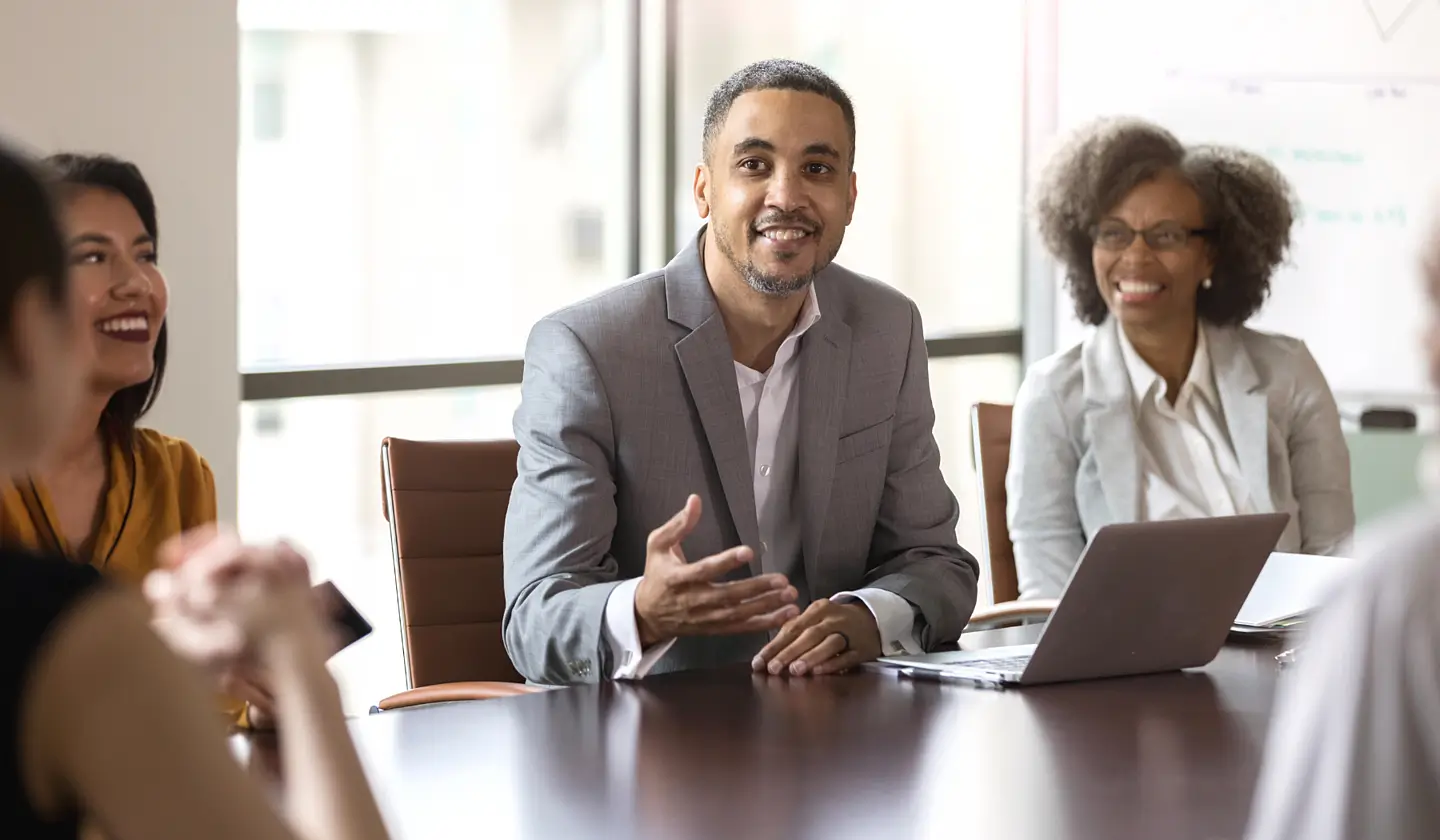 Man speaking at board room table about security