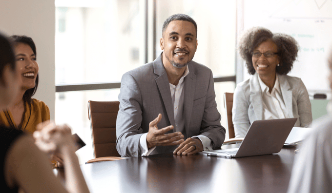 man speaking at board room table