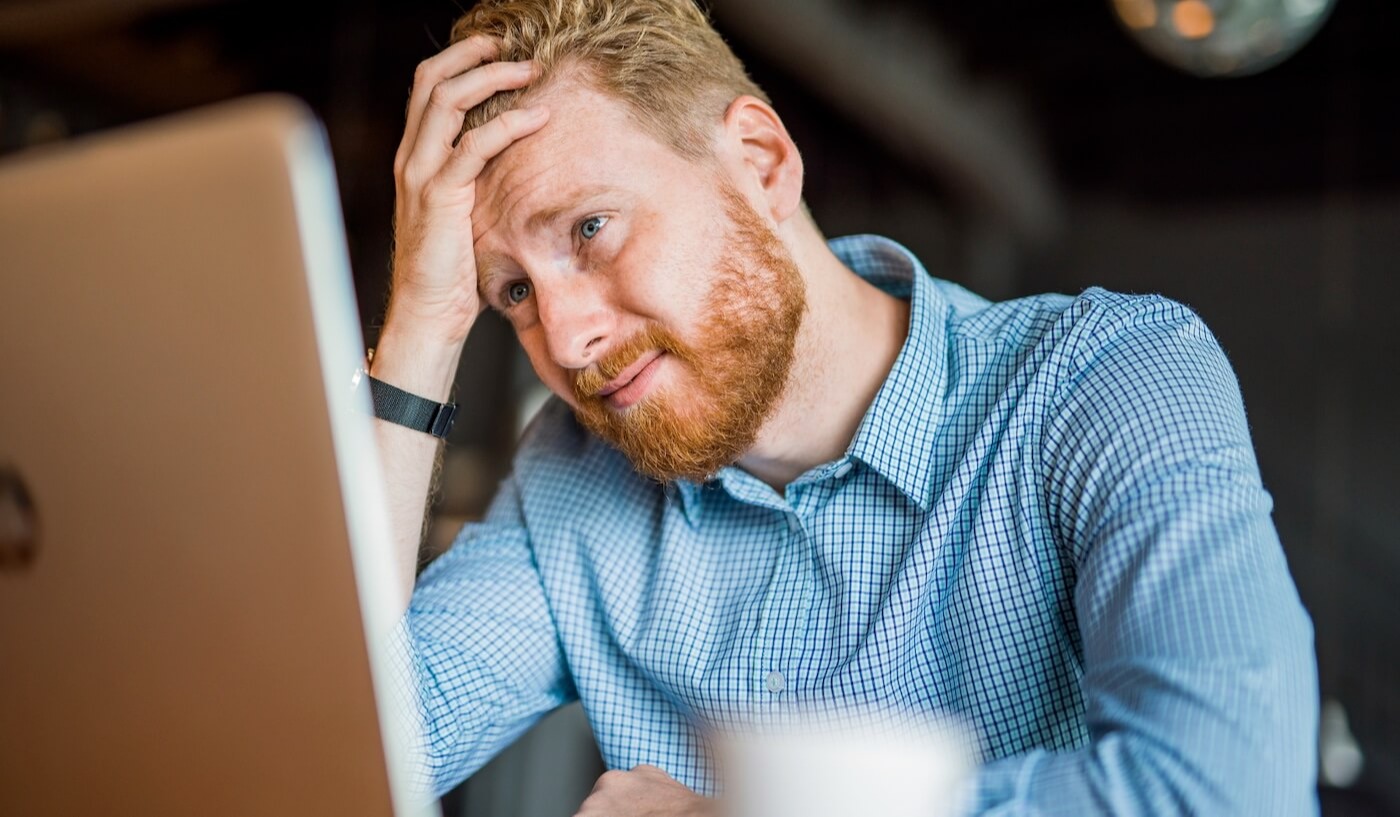 Man making a mistake by email and looking stressed