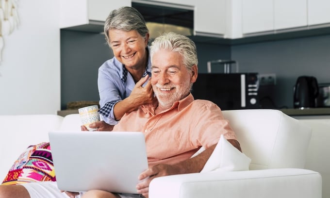 Older couple reading secure email on laptop