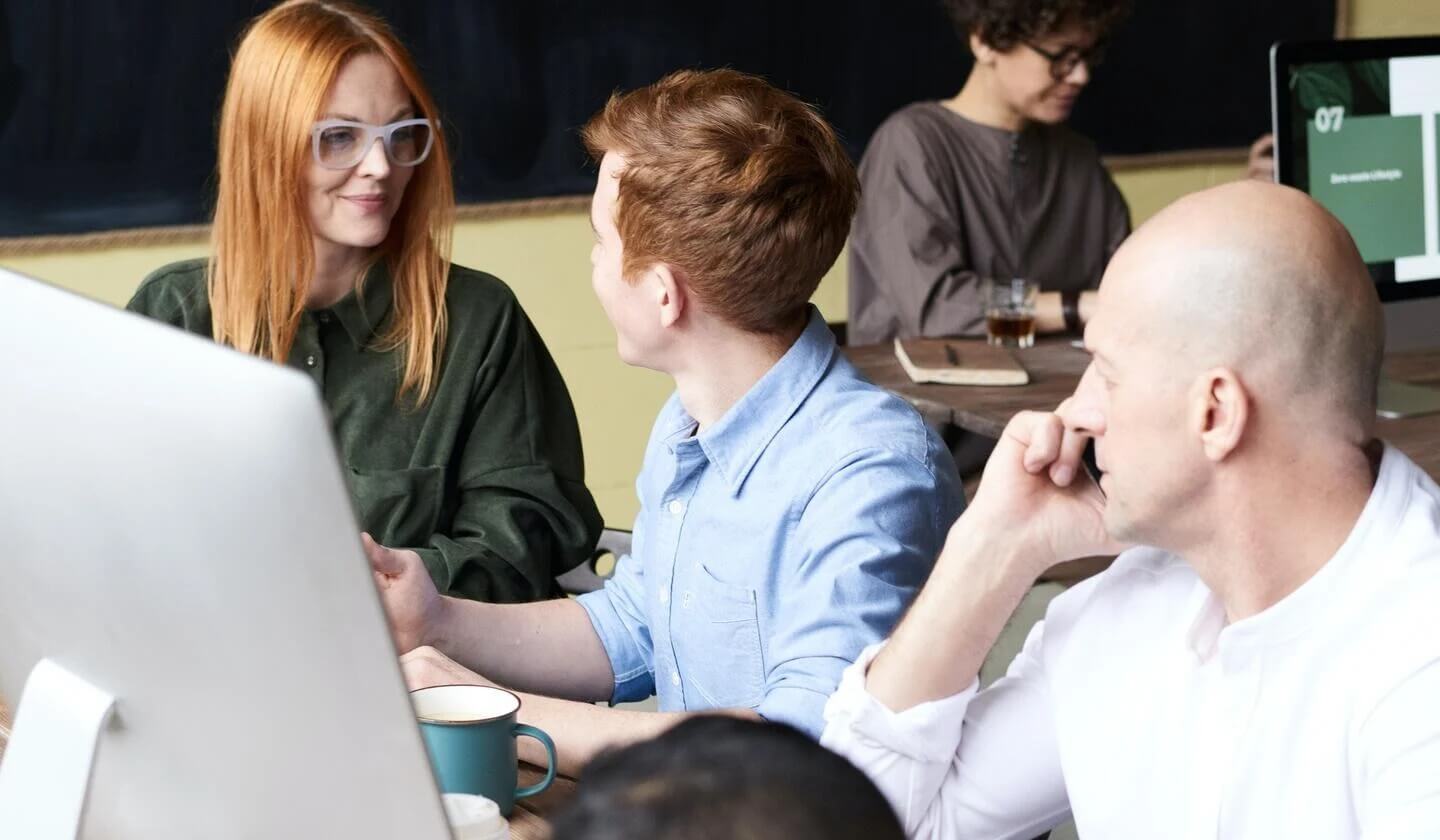 Professionals in Office Discussing Secure Email During Demostration