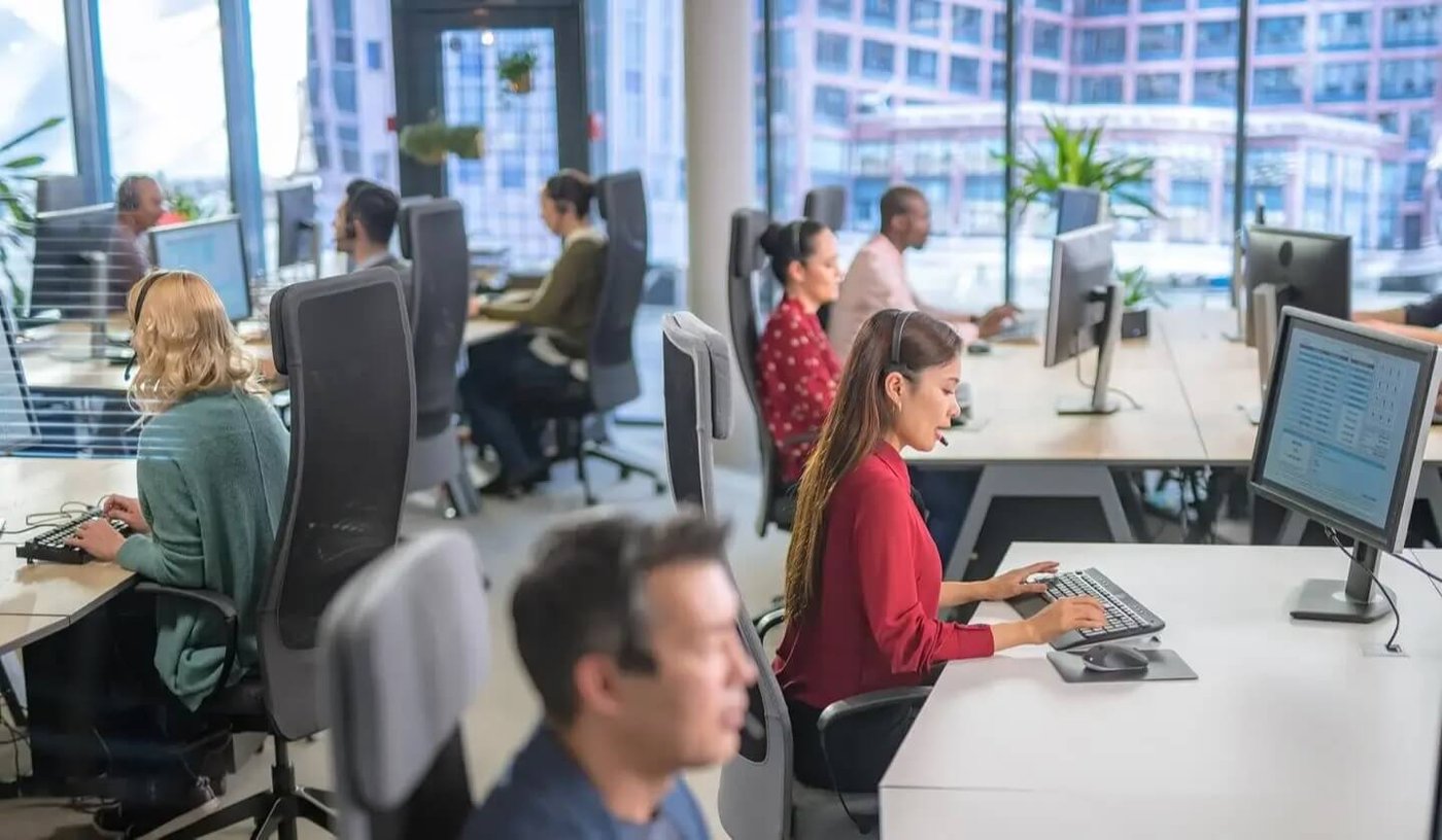 Staff working in office with desktop computers