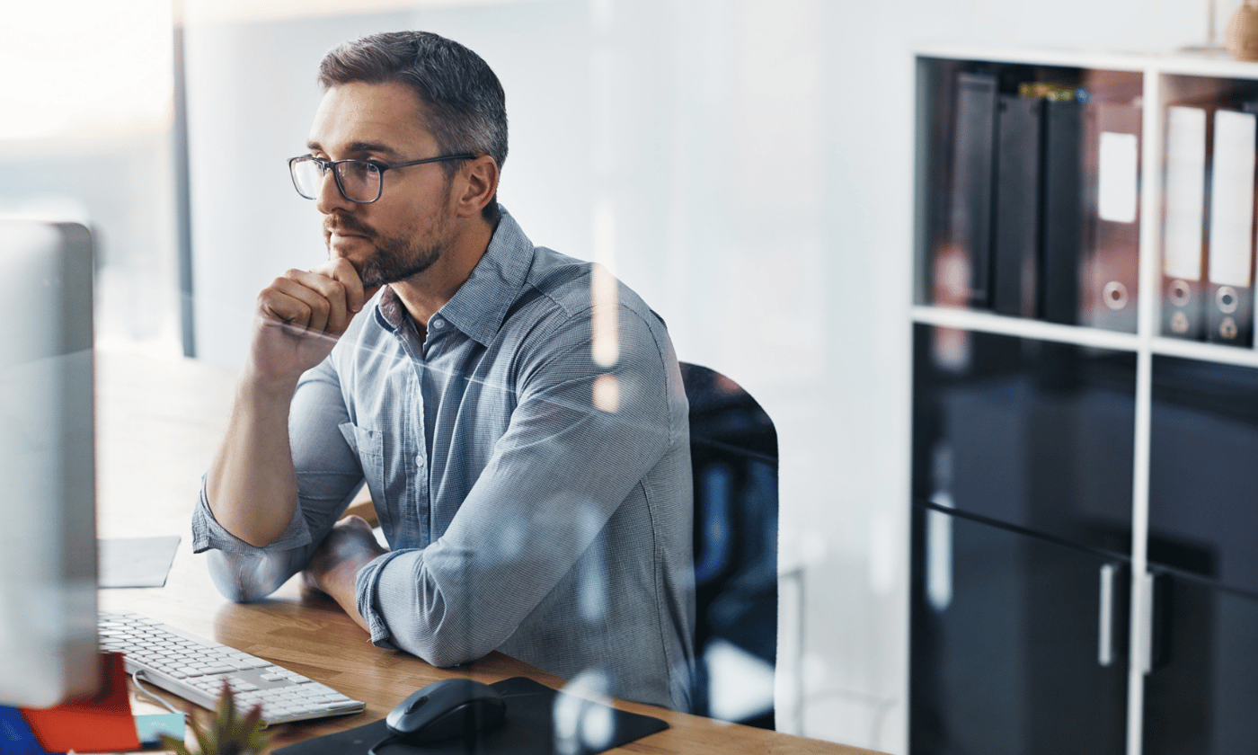 Business man in office looking at secure email on computer