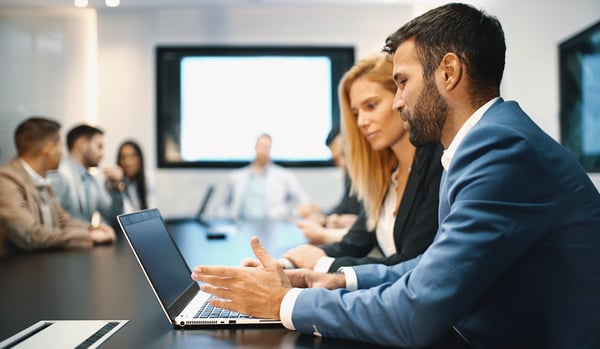 Team in boardroom looking at secure email as an alternative to print