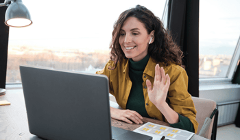 Woman speaking on call in office using laptop