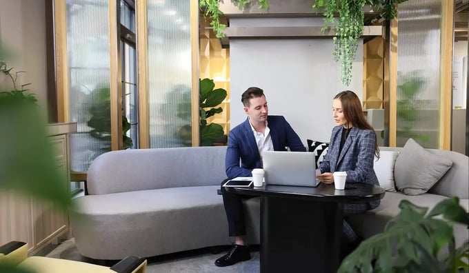 Man and woman in office discussing secure email solution