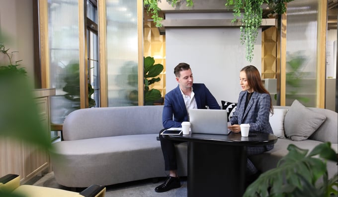 Professional man and woman in office discussing secure email