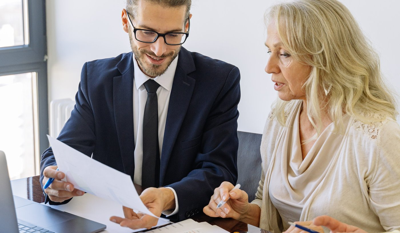 Business man and woman inspect a report