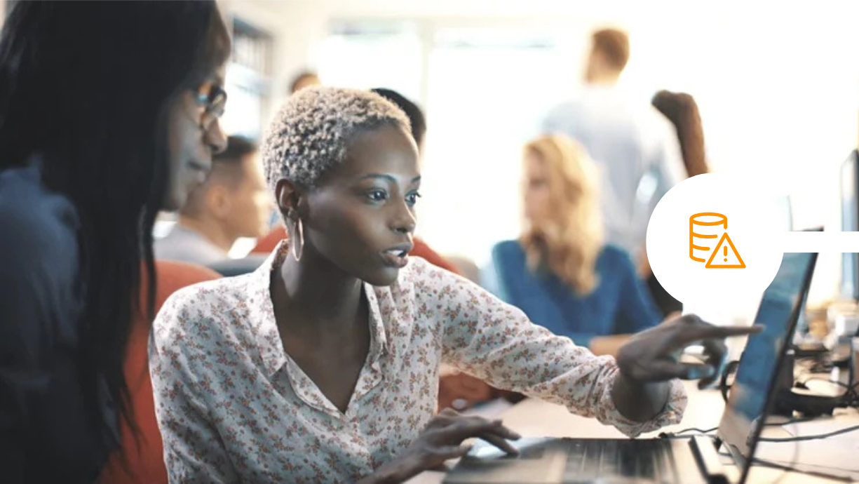 IT team reviewing email security using laptop at office desk